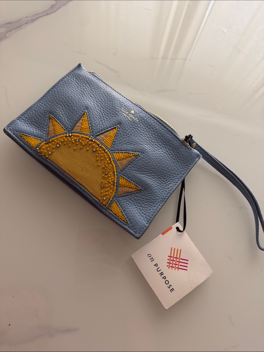 kate spade blue leather wristlet with yellow sun applique